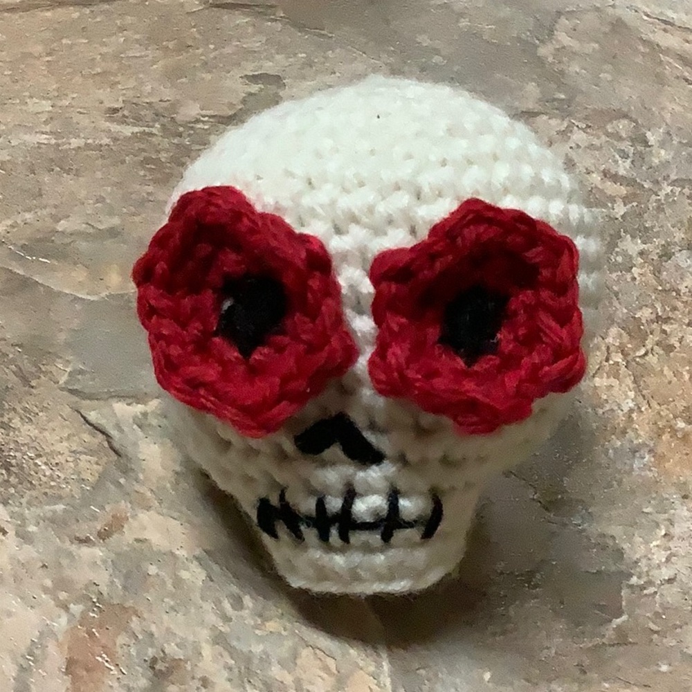 Crochet skull with red flower eyes